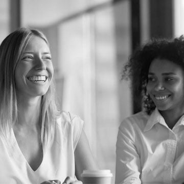 Smiling woman sitting next to friend